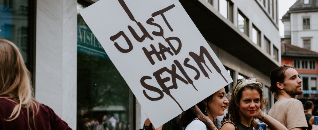 Woman holding I Just Had Sexism placard