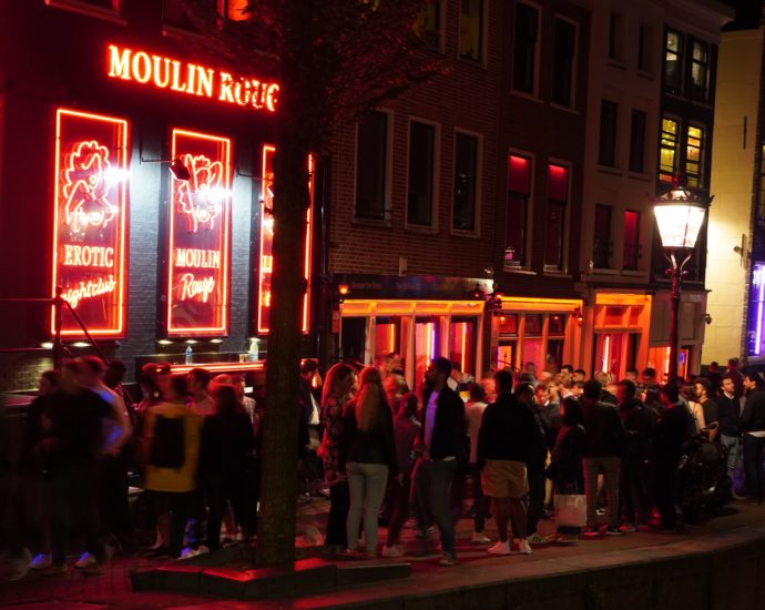 A picture of people outside Amsterdam's Moulin Rouge