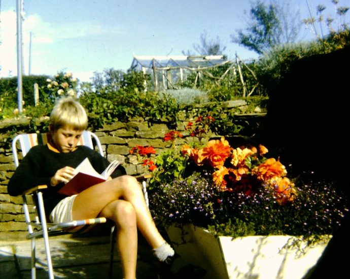 A boy reading outside. Credit to Andy Roberts on Flickr.