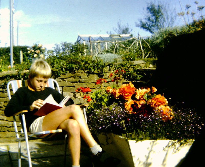 A boy reading outside. Credit to Andy Roberts on Flickr.