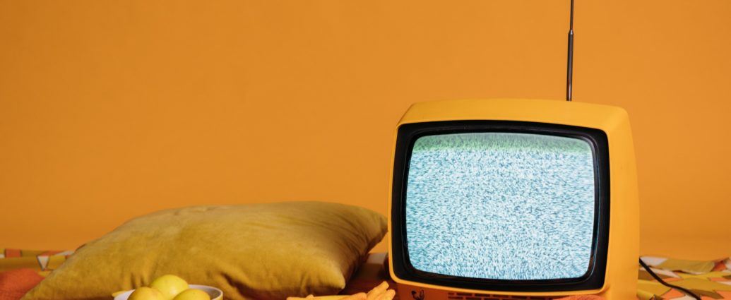 tv in front of yellow background with food