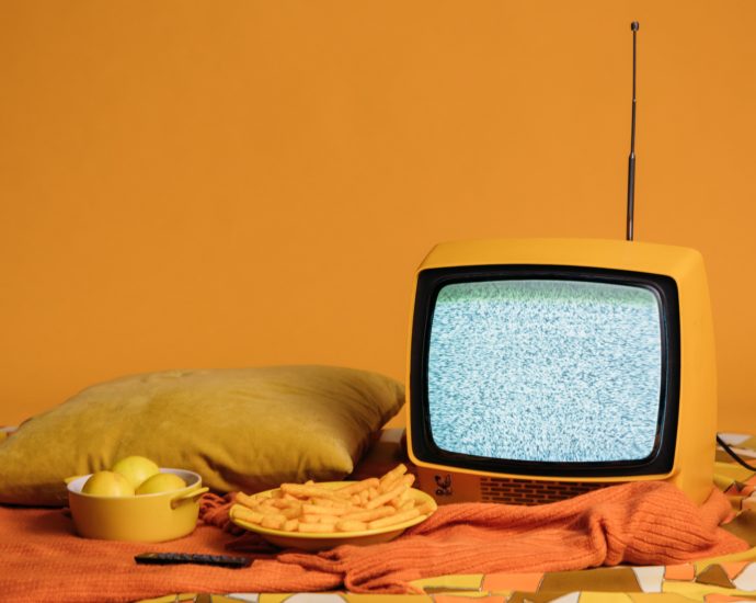 tv in front of yellow background with food