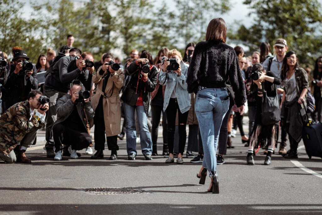 woman being photographed by paparazzi