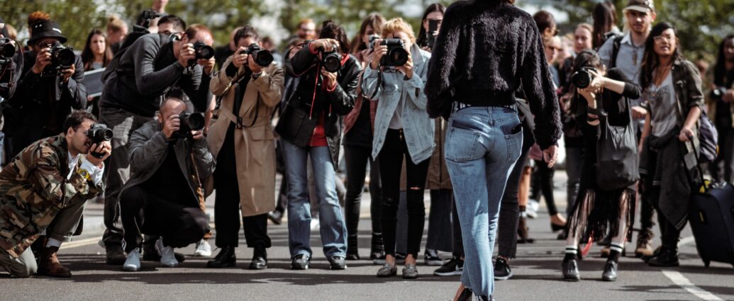 woman being photographed by paparazzi