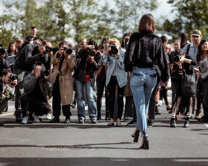 woman being photographed by paparazzi