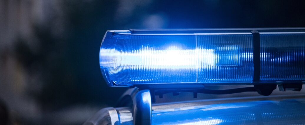 A blue light glowing on top of a police car