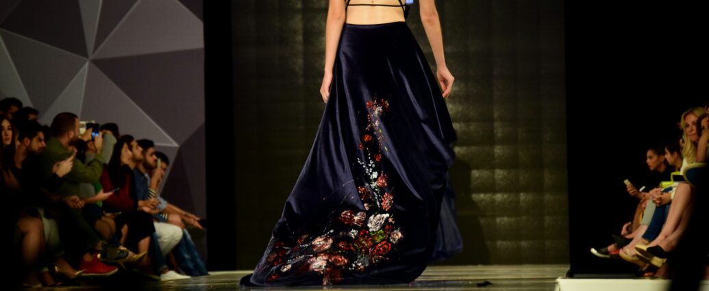 Model walking on catwalk in a fashion show.
