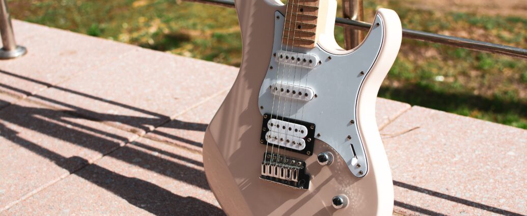 Photo of a pink electric guitar at golden hour