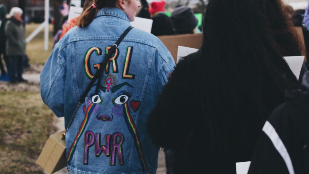 Girl wearing 'Girl Pwr' Jacket