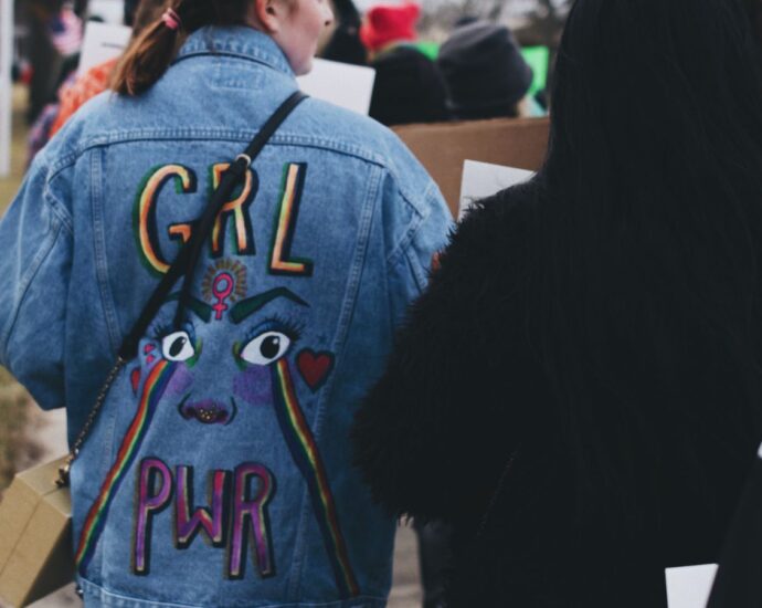 Girl wearing 'Girl Pwr' Jacket