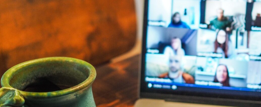 A laptop showing a work call on Zoom.