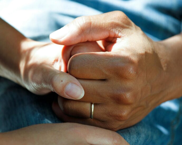 Two hands holding each other