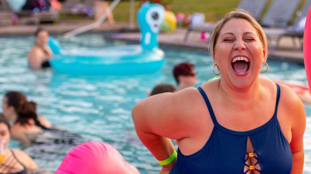 A picture of a smiling woman in a swimming pool