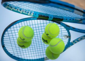 Multiple balls on two tennis racket.