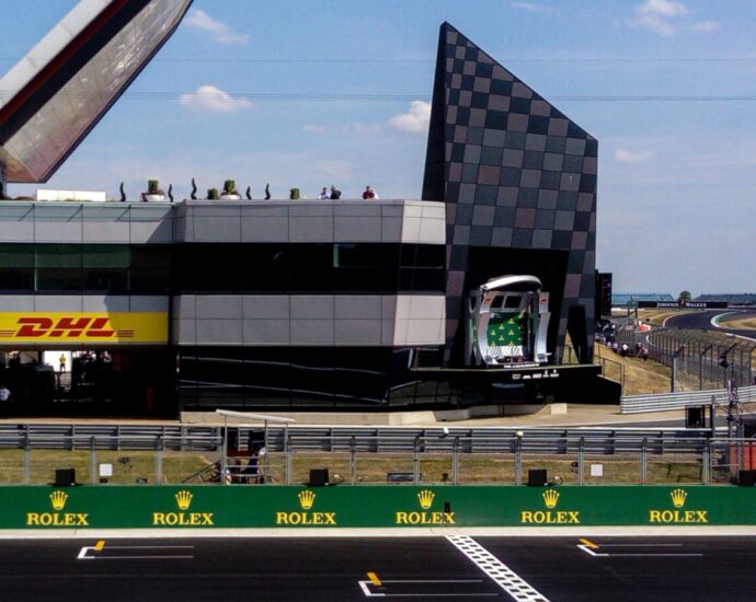 The pitlane entrance, starting grid and podium at Silverstone motor racing circuit during the British Grand Prix. Since this year's Silverstone, it has been announced that Daniel Ricciardo has returned to the full line up!