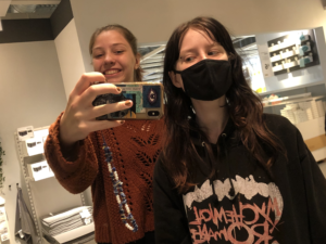Two people in a mirror selfie, one (author of the article) wearing a mask.