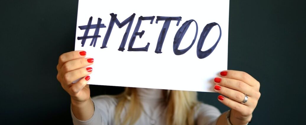 Woman holding paper that says "me too".