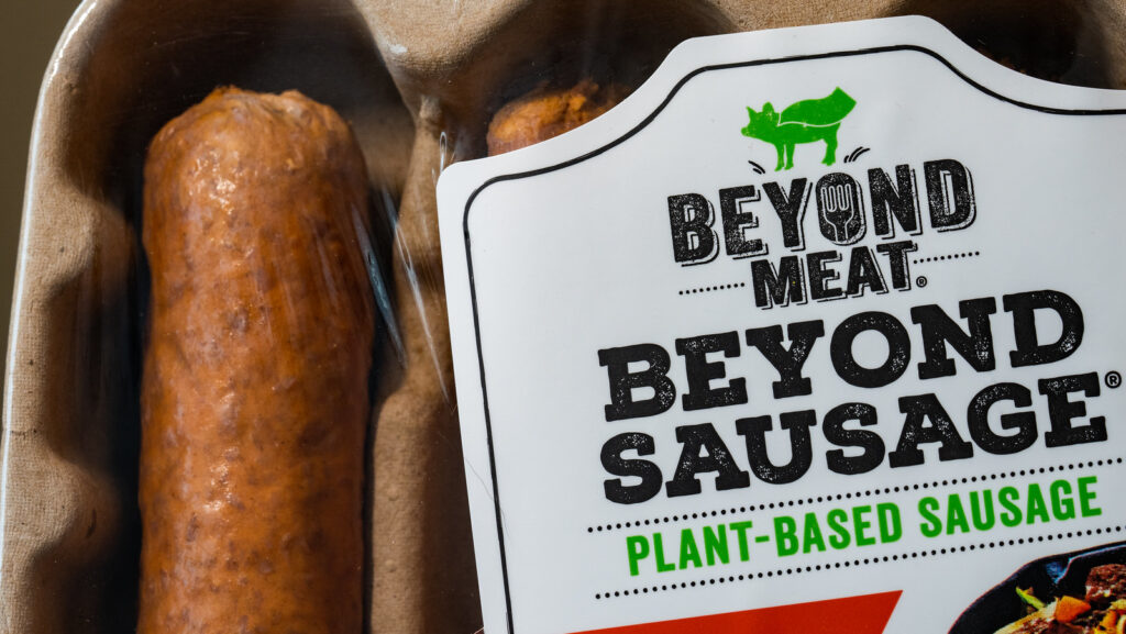 Image shows a packet of 'beyond meat' sausages: a meat industry sausage alternative.
