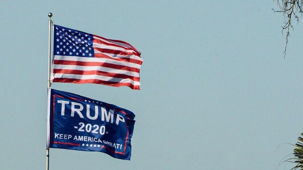 An image of a USA flag, and a Trump 2020 presidential flag.