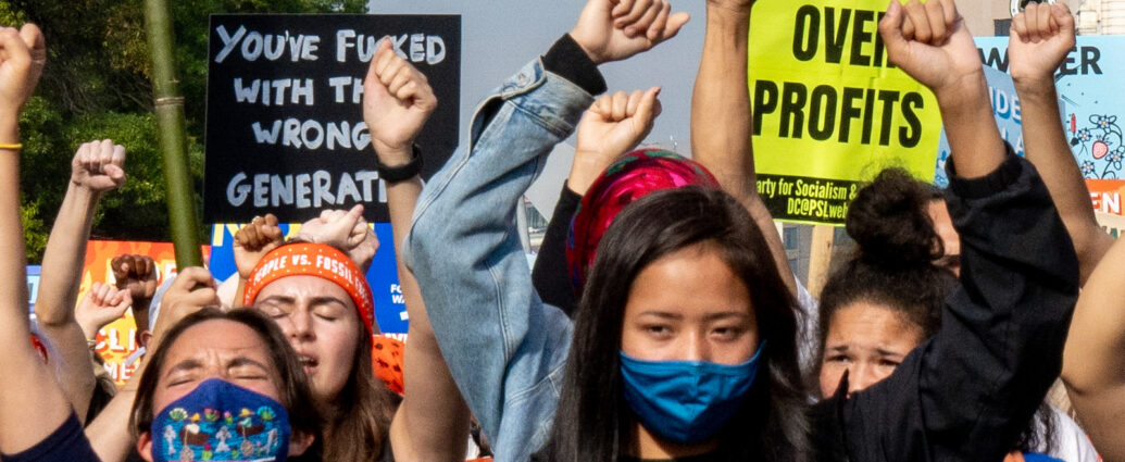 Image of climate protesters on Pennsylvania Avenue. People vs. Fossil Fuels, 10/15/21