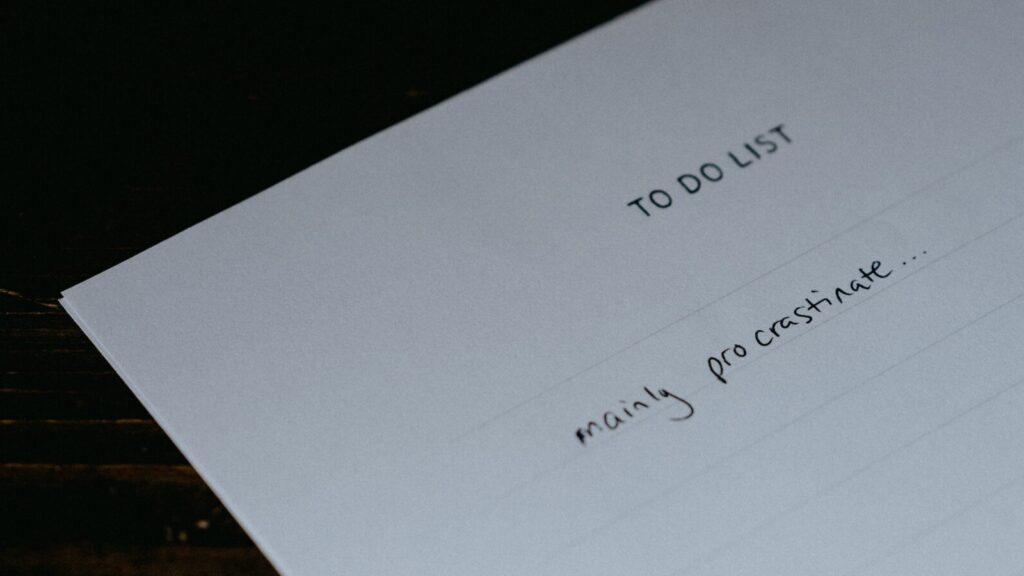 Image shows a piece of paper with a to-do list that says 'mainly procrastinate' [procrastination]