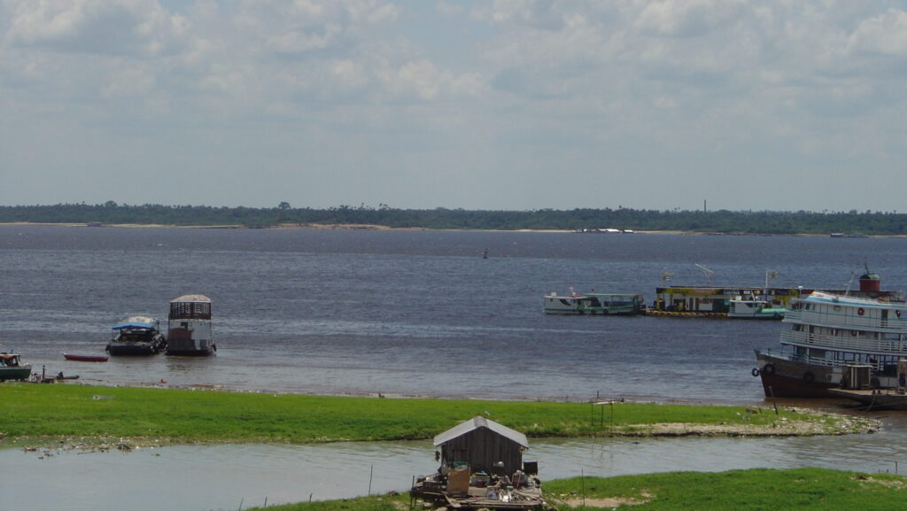 Image shows the Rio Negro from Porto da Manaus Moderna in Brazil.