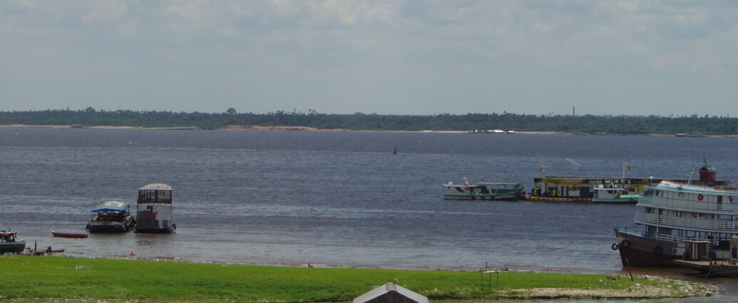 Image shows the Rio Negro from Porto da Manaus Moderna in Brazil.