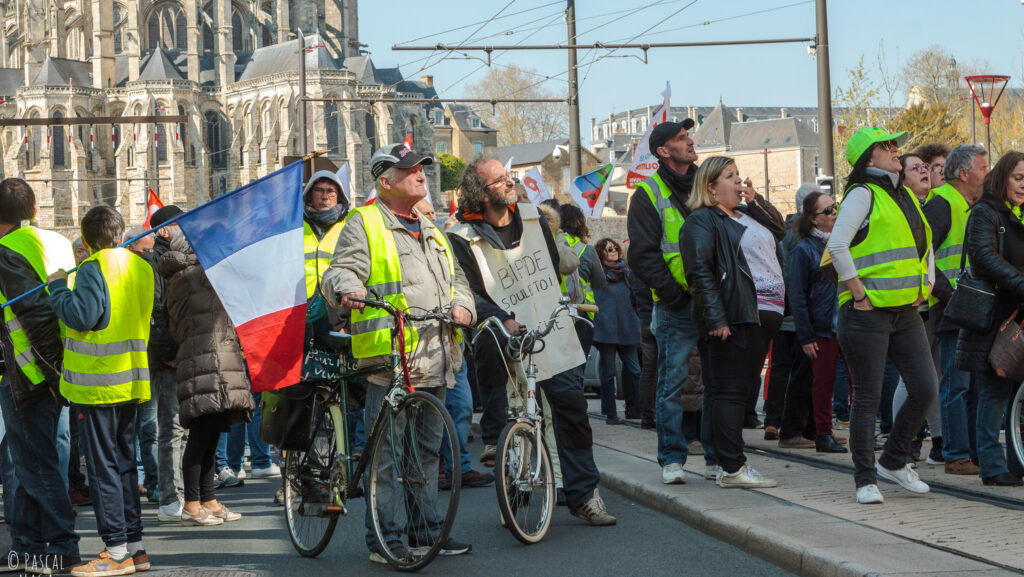 Protestors from the Yellow Vest movement holding the French flag, 2019.