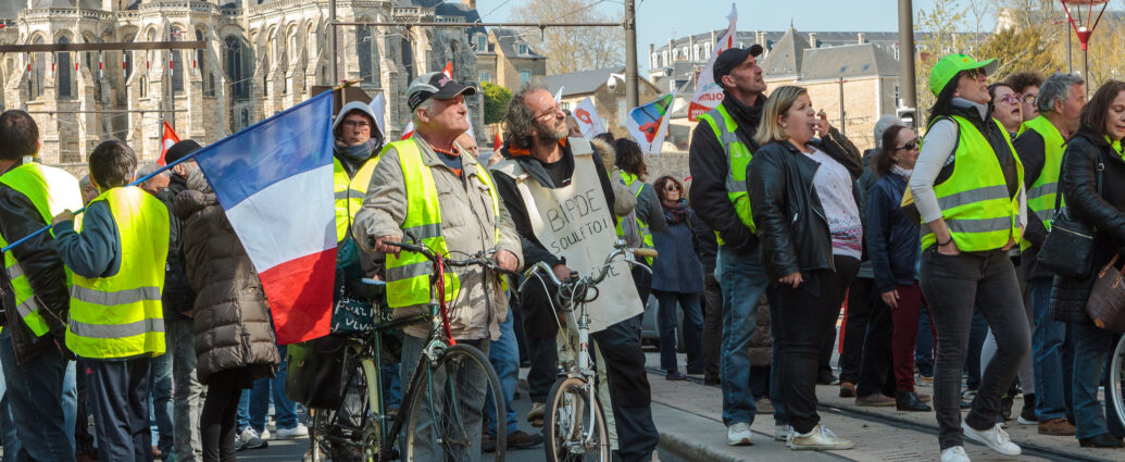 Protestors from the Yellow Vest movement holding the French flag, 2019.