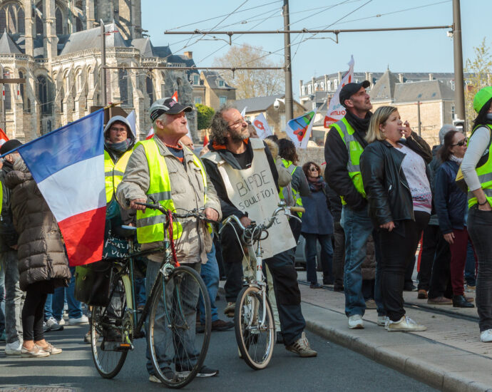Protestors from the Yellow Vest movement holding the French flag, 2019.
