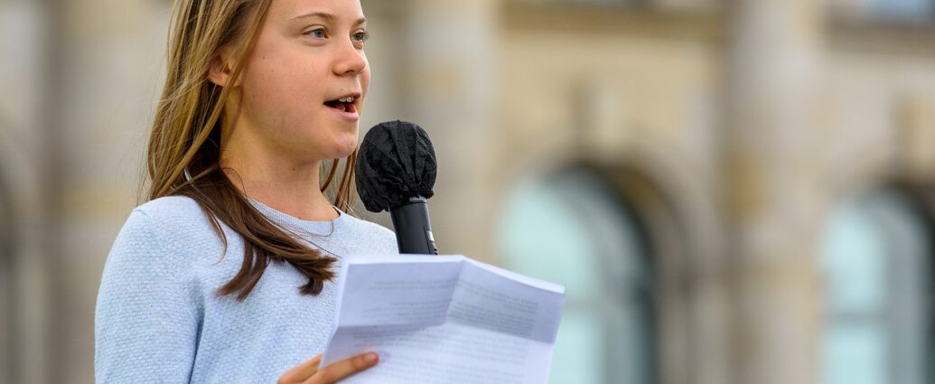 Image shows Greta Thunberg reading speech.