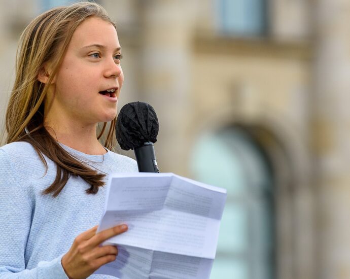 Image shows Greta Thunberg reading speech.