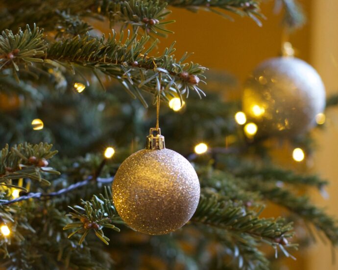 Christmas tree decorated with lights and gold baubles.