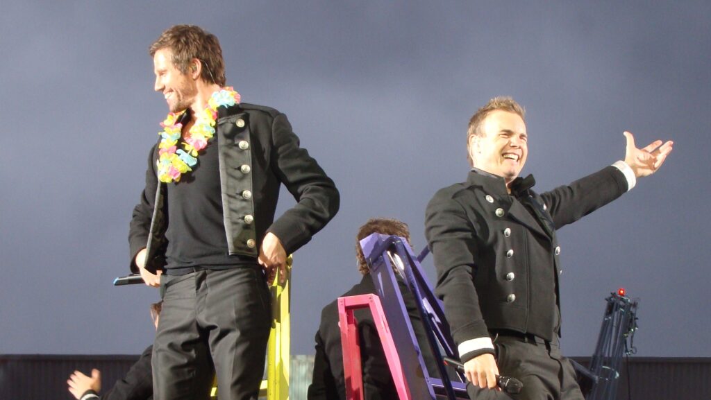 Howard Donald and Gary Barlow of Take That performing live on stage (2009).