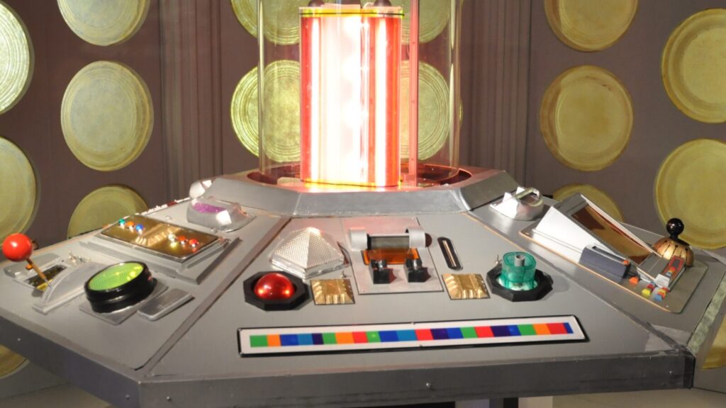 The futuristic control room of the TARDIS with lots of buttons and flashing lights.