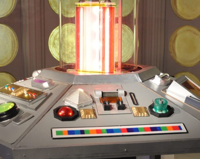 The futuristic control room of the TARDIS with lots of buttons and flashing lights.