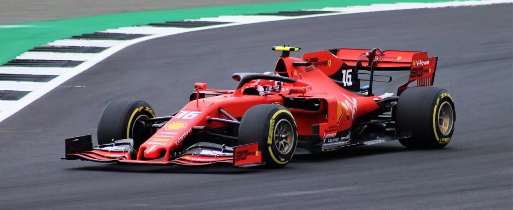 Image shows a red formula 1 car on a racing track.
