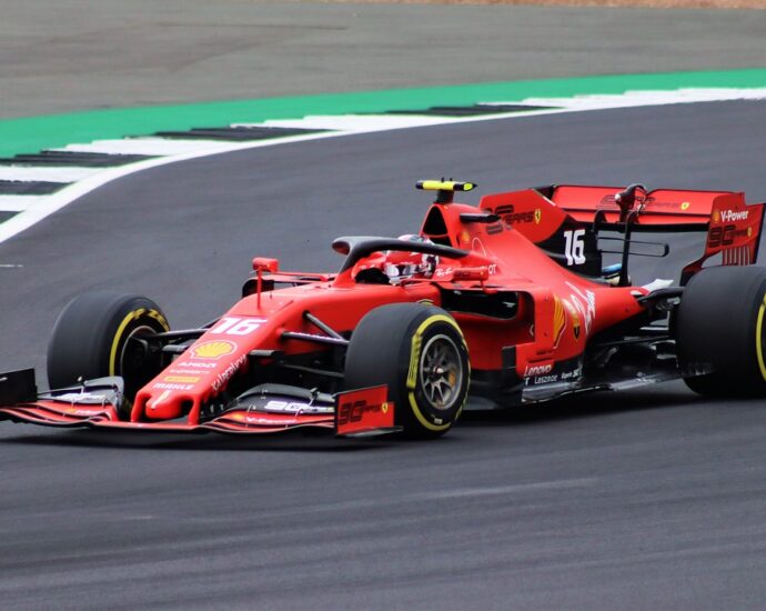 Image shows a red formula 1 car on a racing track.