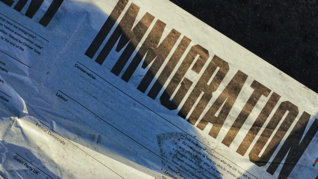 Newspaper with headline 'IMMIGRATION', portraying asylum seekers rhetoric.