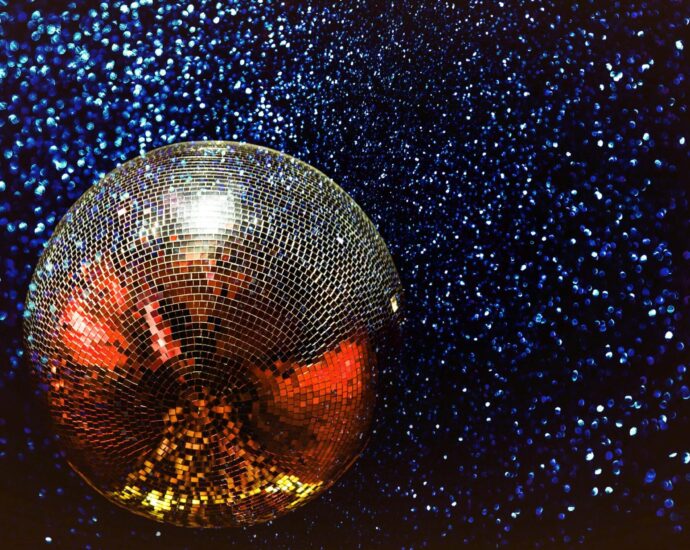 silver disco ball on sparkly starry backdrop