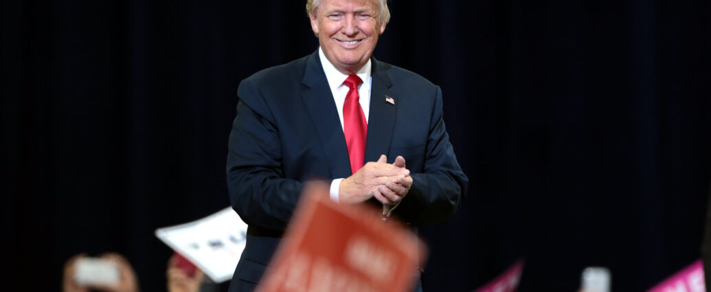 Donald Trump surrounded by Republican supporters.