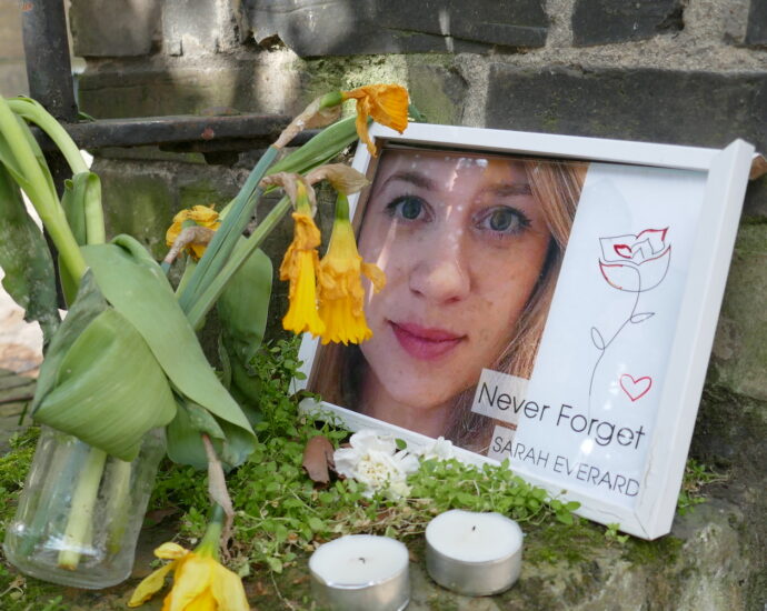 A memorial for Sarah Everard, surrounded by flowers and candles, with an image reading "Never Forget Sarah Everard". [Labour Proposes Mandatory Sexual Violence Training For Police]