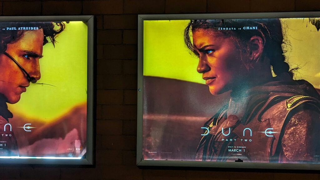 Image shows promotional posters of Timothee Chalamet and Zendaya for Dune: Part Two.