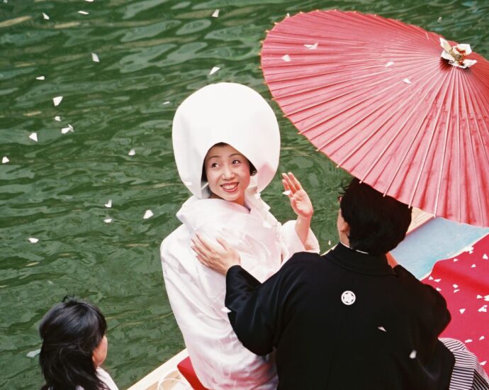 Japanese bride celebrates on a boat on her wedding day. [Japanese law married surnames]