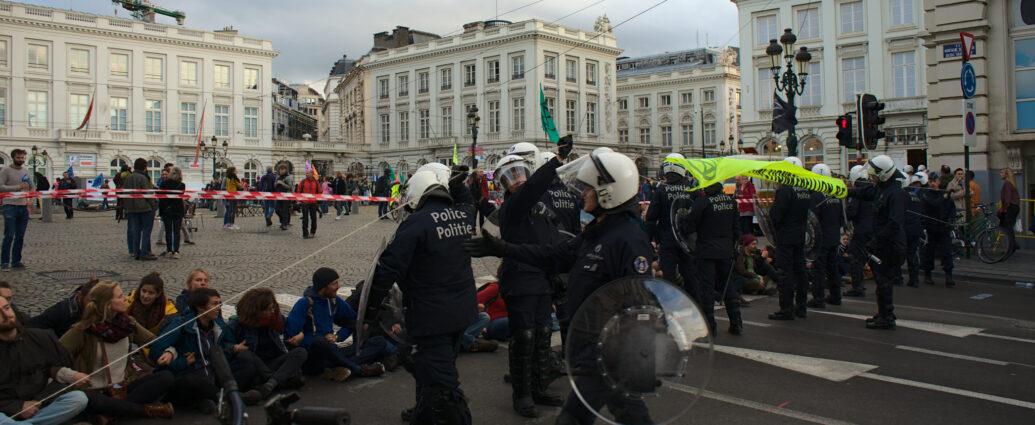 Police approach sitting protestors at an Extinction Rebellion public demonstration, 2019.