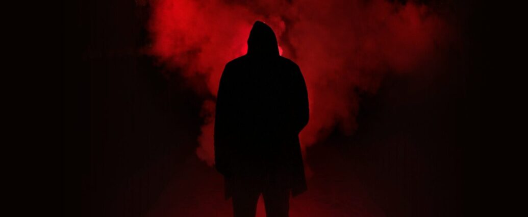 A shadowy figure stands in front of a red fog. Why are some of the "red-pilled" commentators of the "manosphere" women?