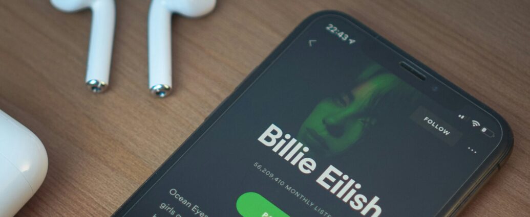 A phone plays a Billie Eilish album on Spotify.