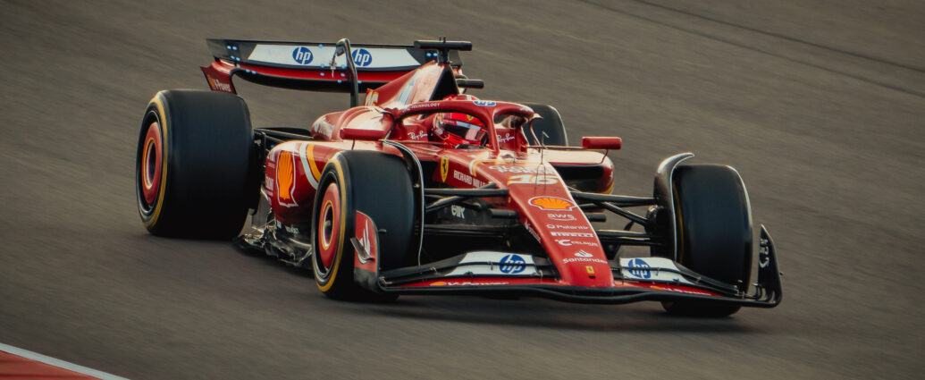Red Formula 1 car on a track, heading towards the camera