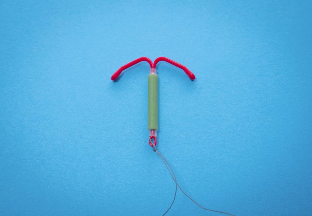 An IUD against a blue background