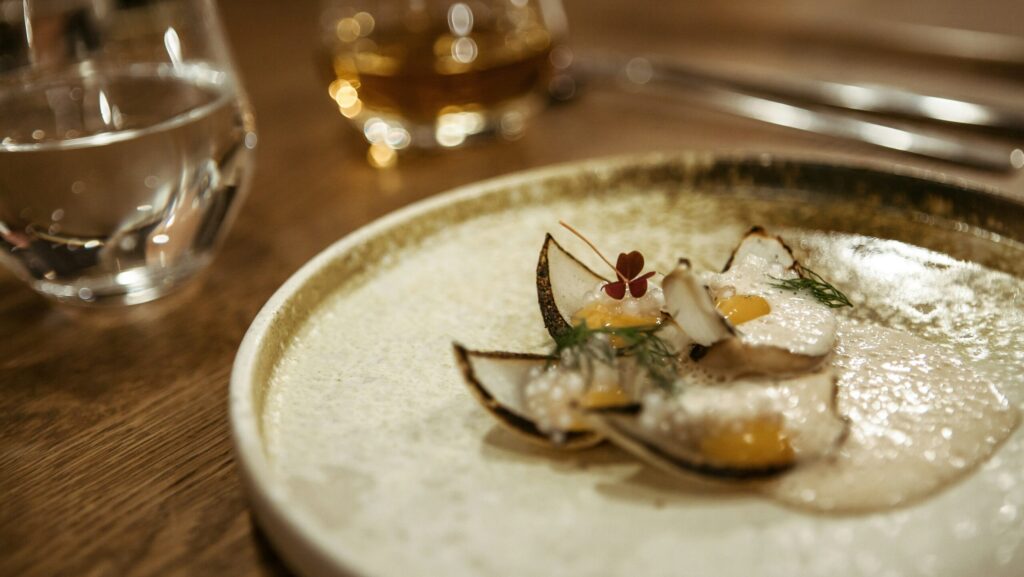 A small plate with a tiny portion of food on it.